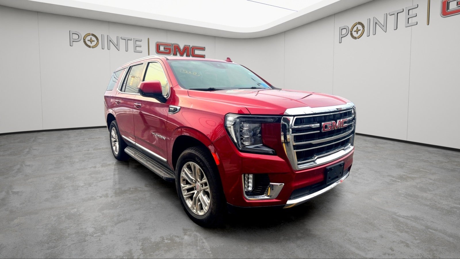 2023 GMC Yukon SLT in Volcanic Red Tintcoat — front three-quarter view